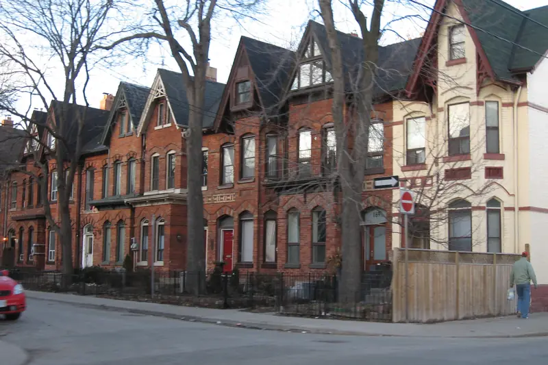 Victorian red-brick row houses on a Toronto street corner
